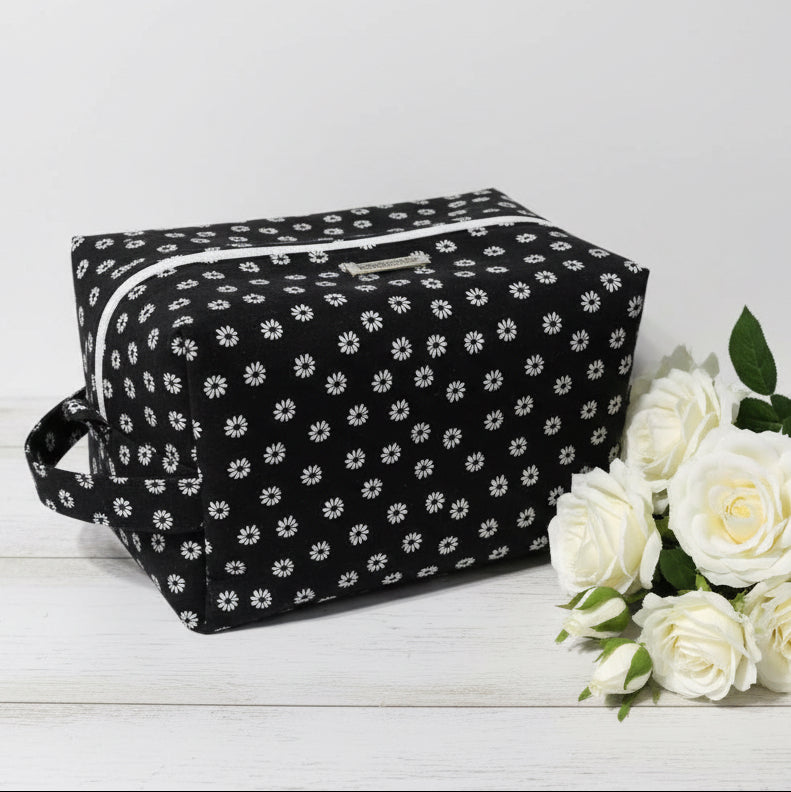 Black toiletry bag with white floral pattern 