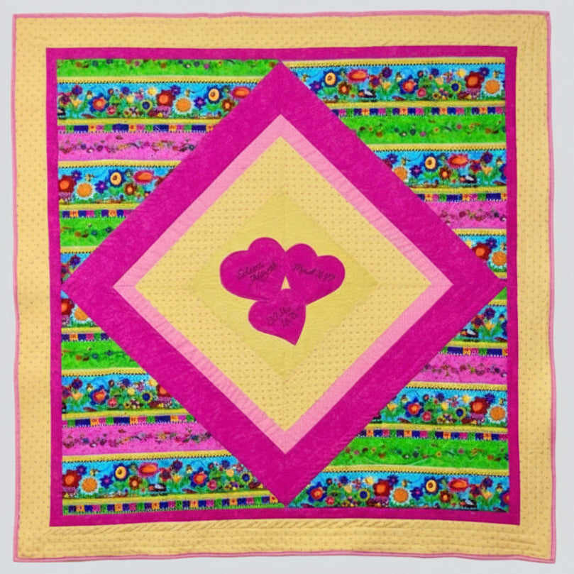 Colorful quilt with pink hearts and floral patterns