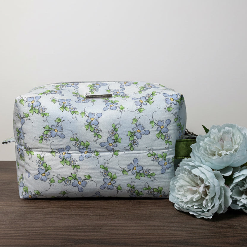 Floral-patterned bag with a green strap 