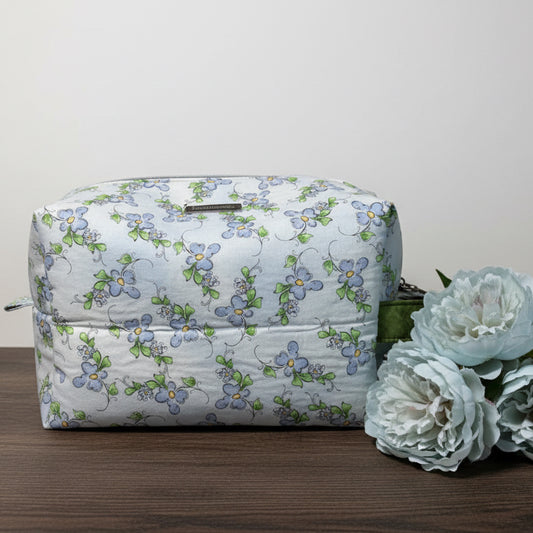 Floral-patterned bag with a green strap 