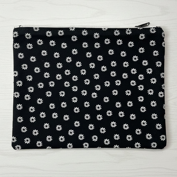 Black pouch with white floral pattern 