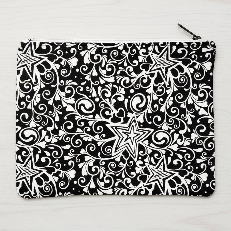 Black and white patterned pouch with stars and swirls 