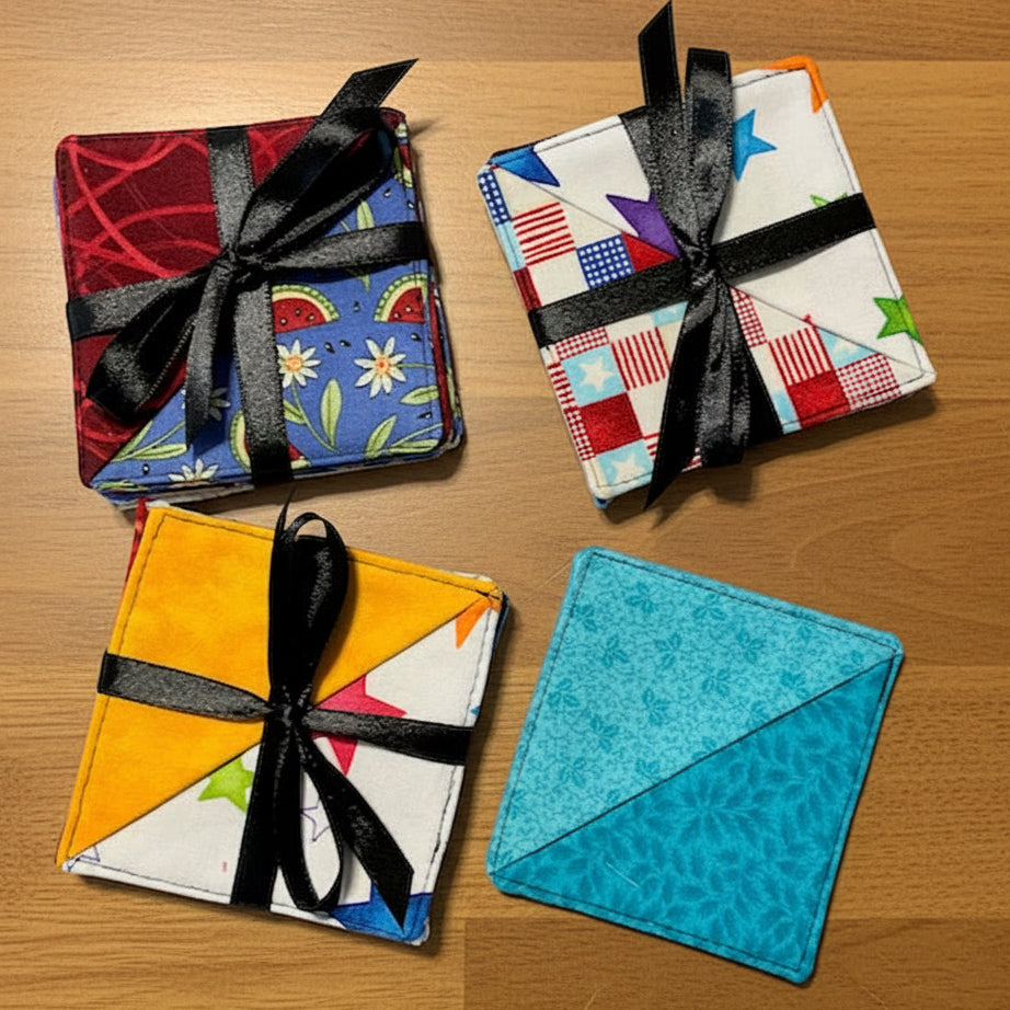 Four colorful fabric coasters with black ribbons 