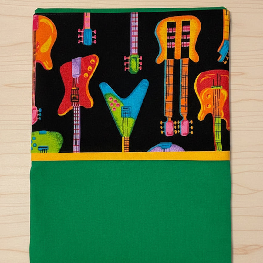 Green Pillowcase with colorful guitar pattern on a black background