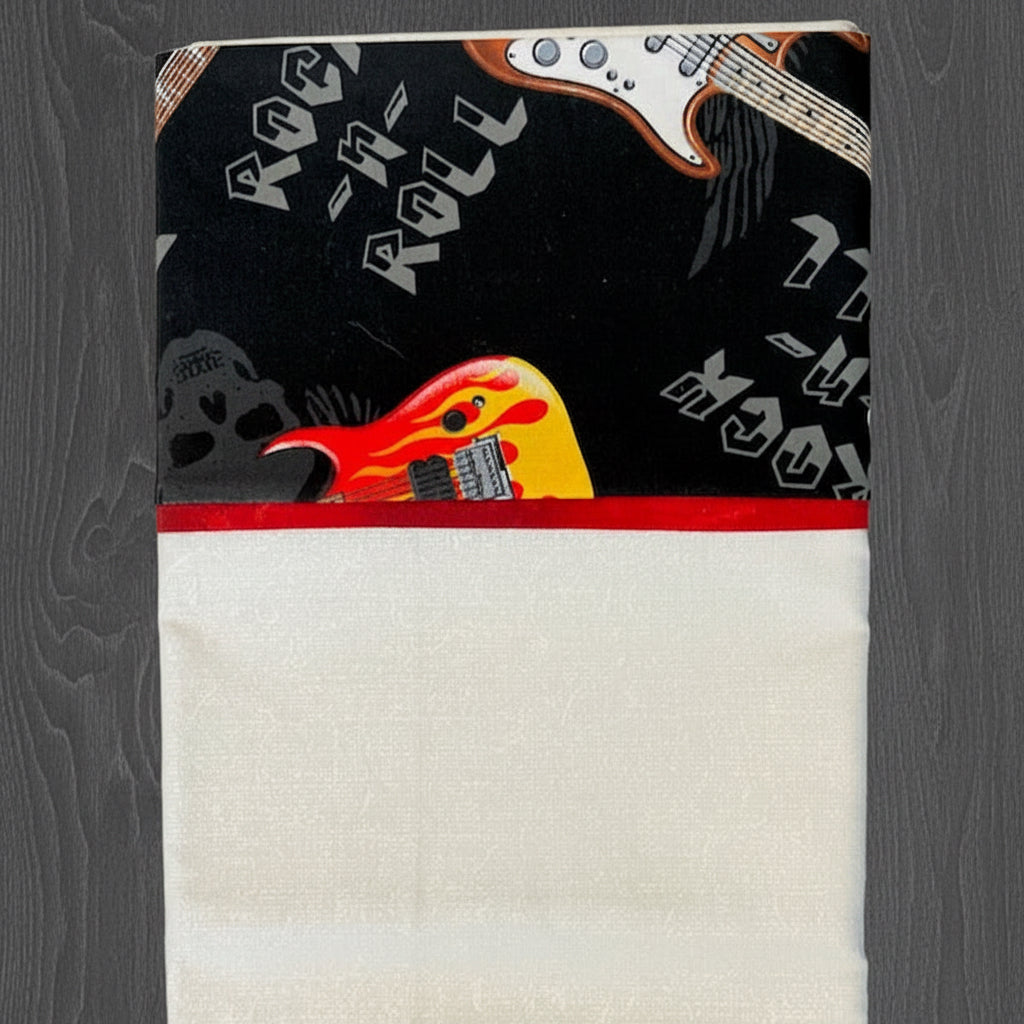Pillowcase with guitar design on the cover against a black background