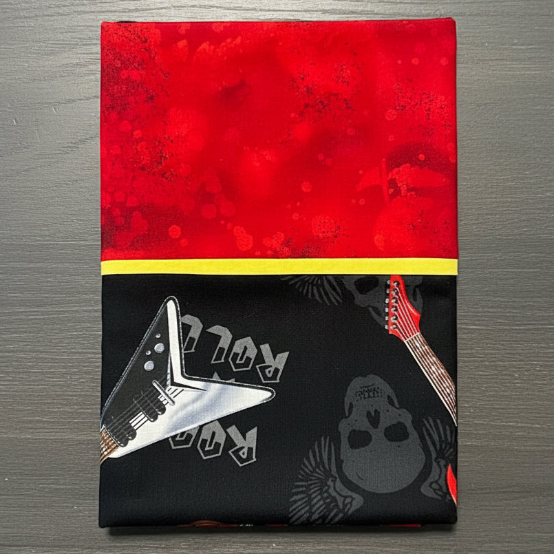 Pillowcases with red, black, and yellow design featuring a guitar and skull.