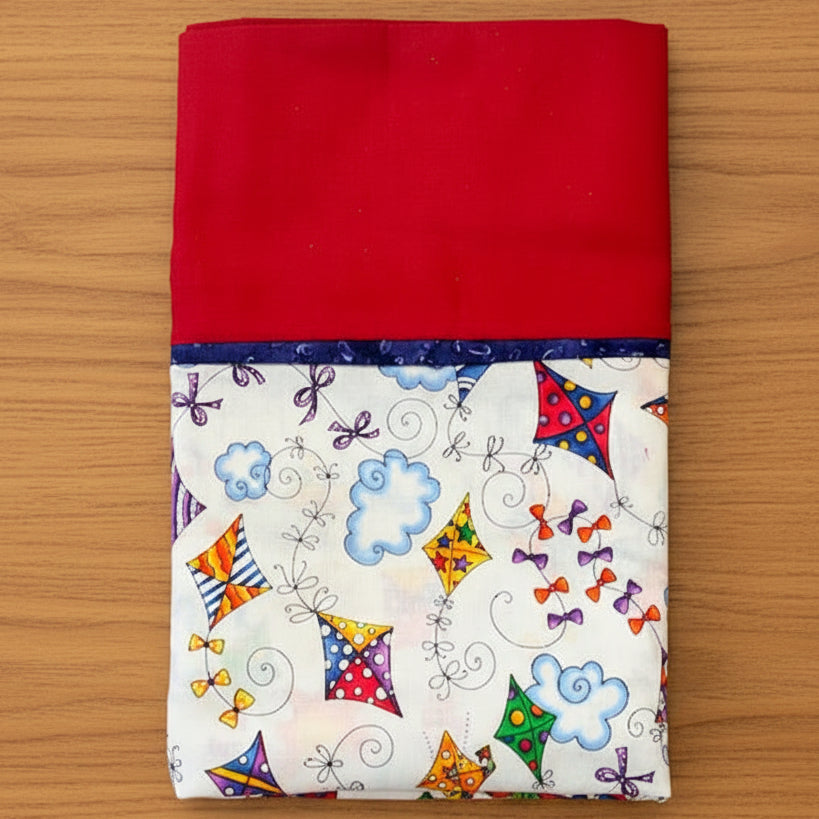 Pillowcase with Red fabric with a colorful kite and bow pattern 