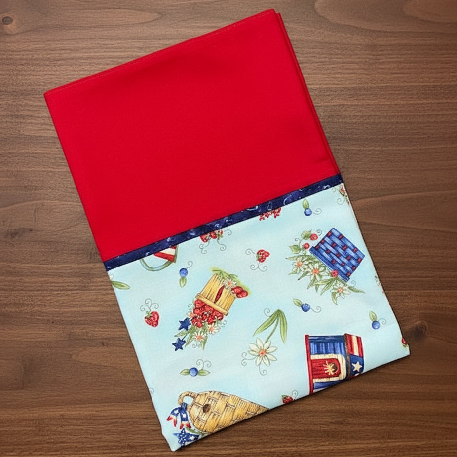 Pillowcase with red top and colorful picnic-themed bottom