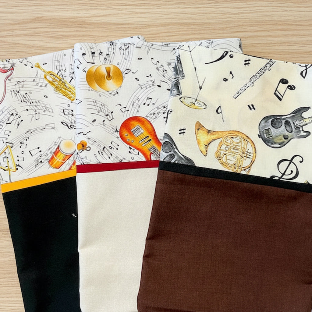 Pillowcases with musical instrument and note patterns on a white background