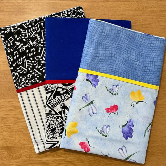 Collection of patterned pillowcases including musical notes, blue, and floral designs.