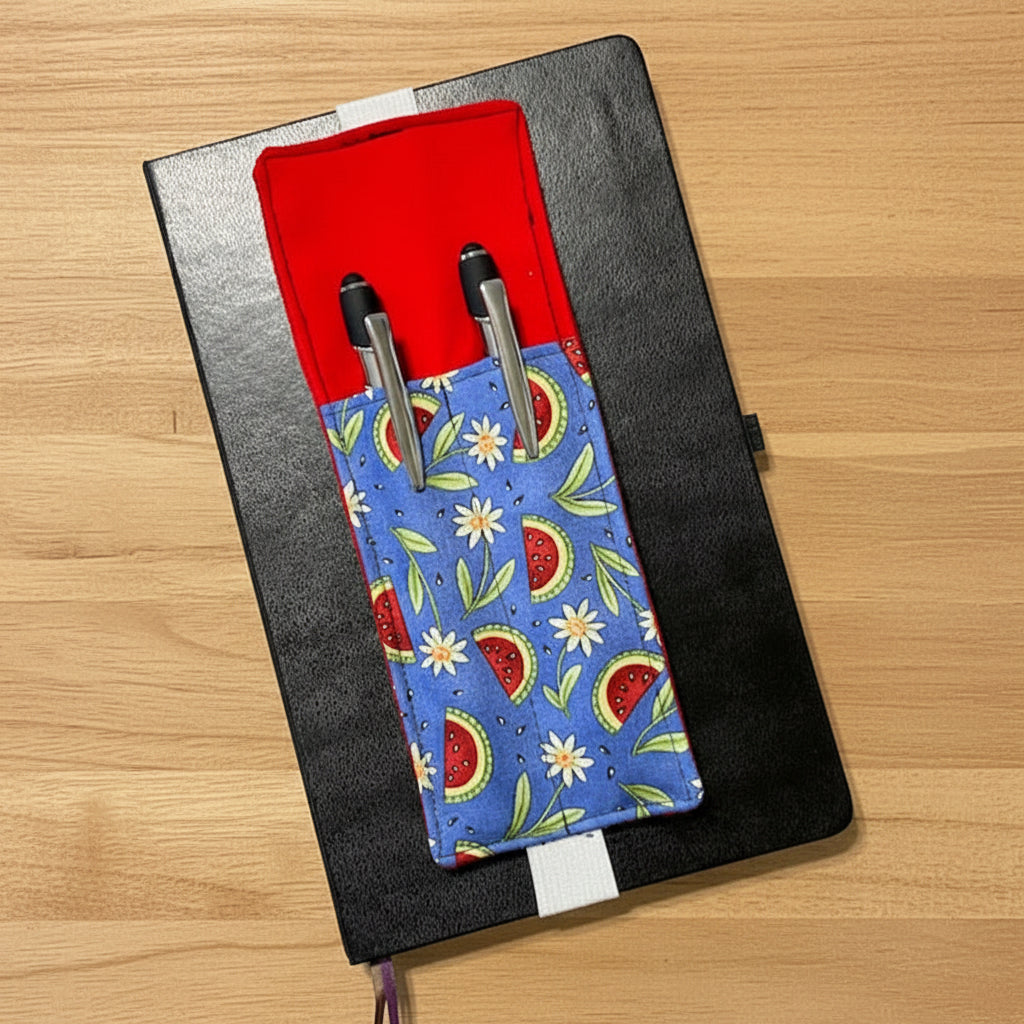 Notebook with pen holder featuring watermelon pattern on a white background