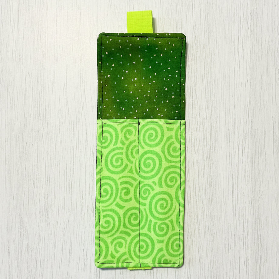 Green fabric pouch with spiral pattern on a white background