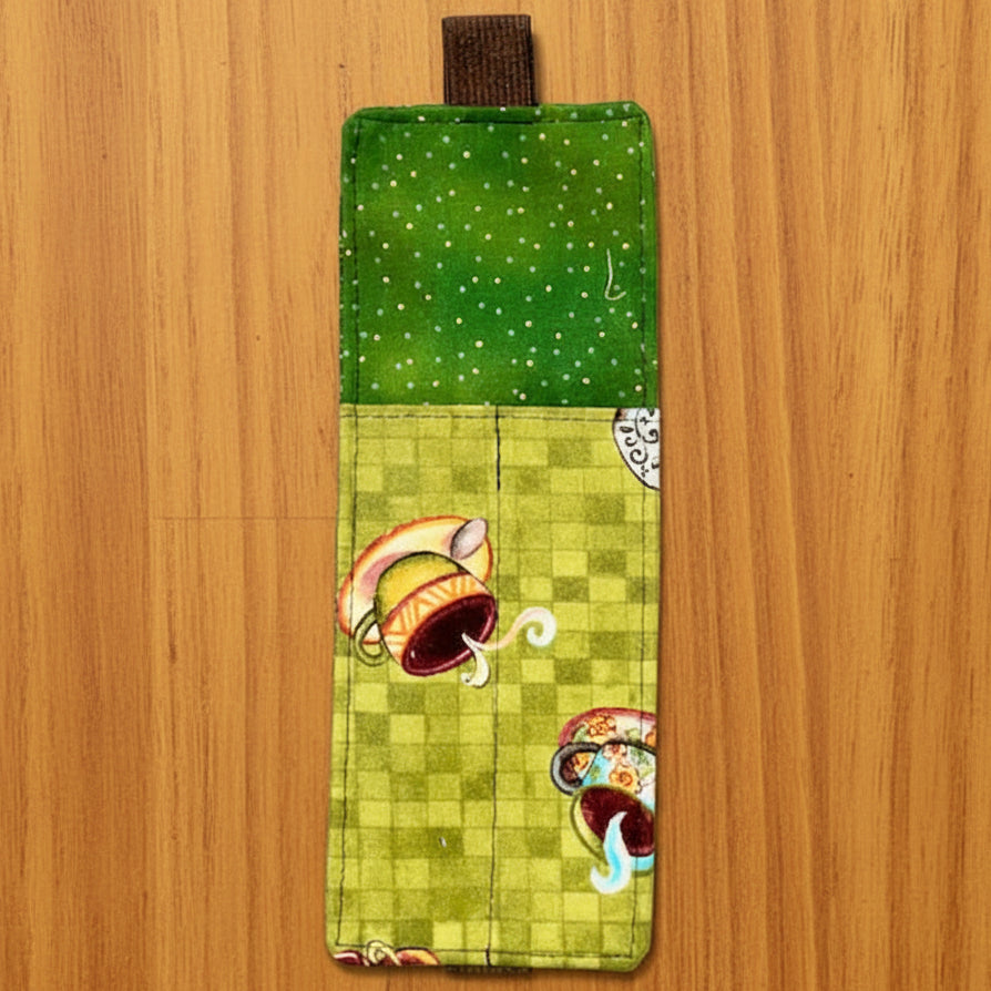 Green fabric pouch with colorful designs 