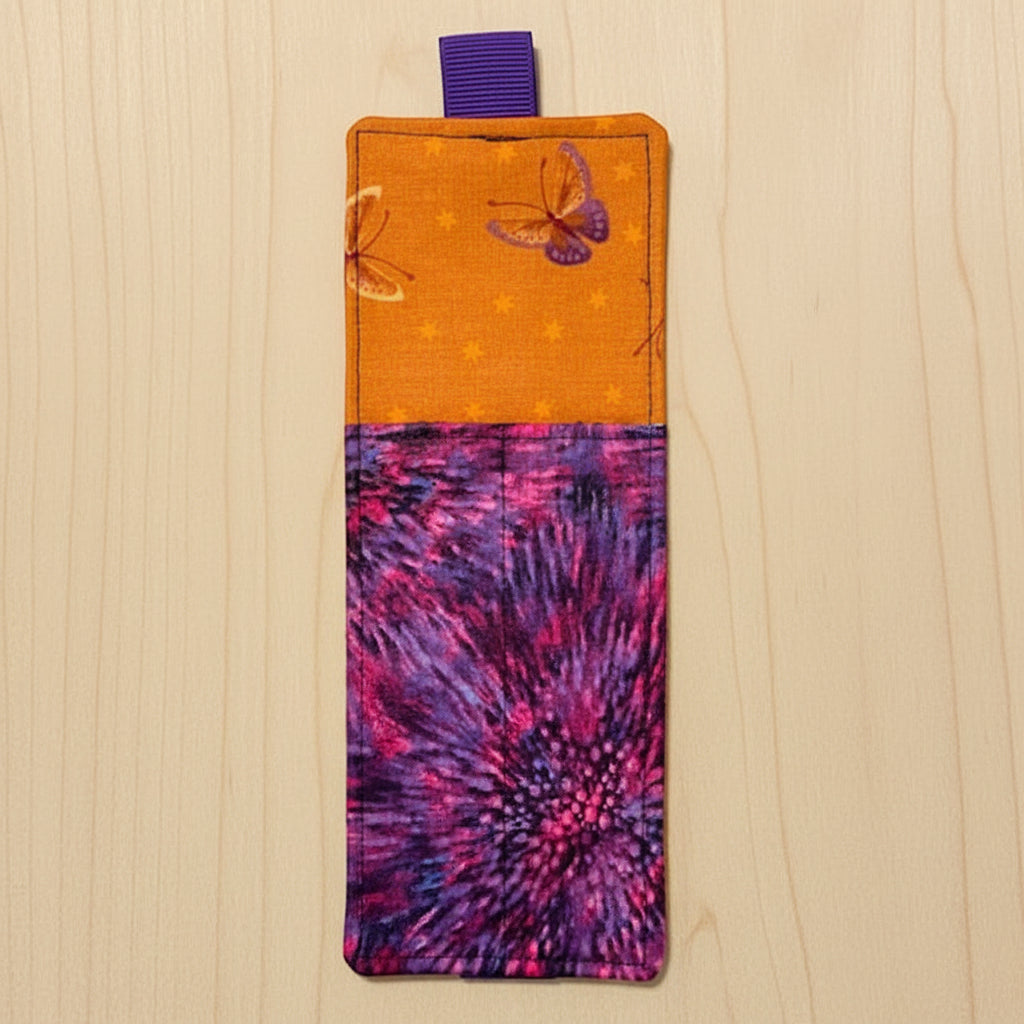 Colorful fabric pouch with butterfly design on a white background