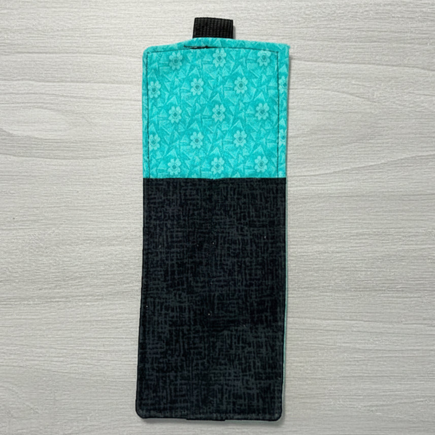 Two-tone black and turquoise phone case on a light gray background