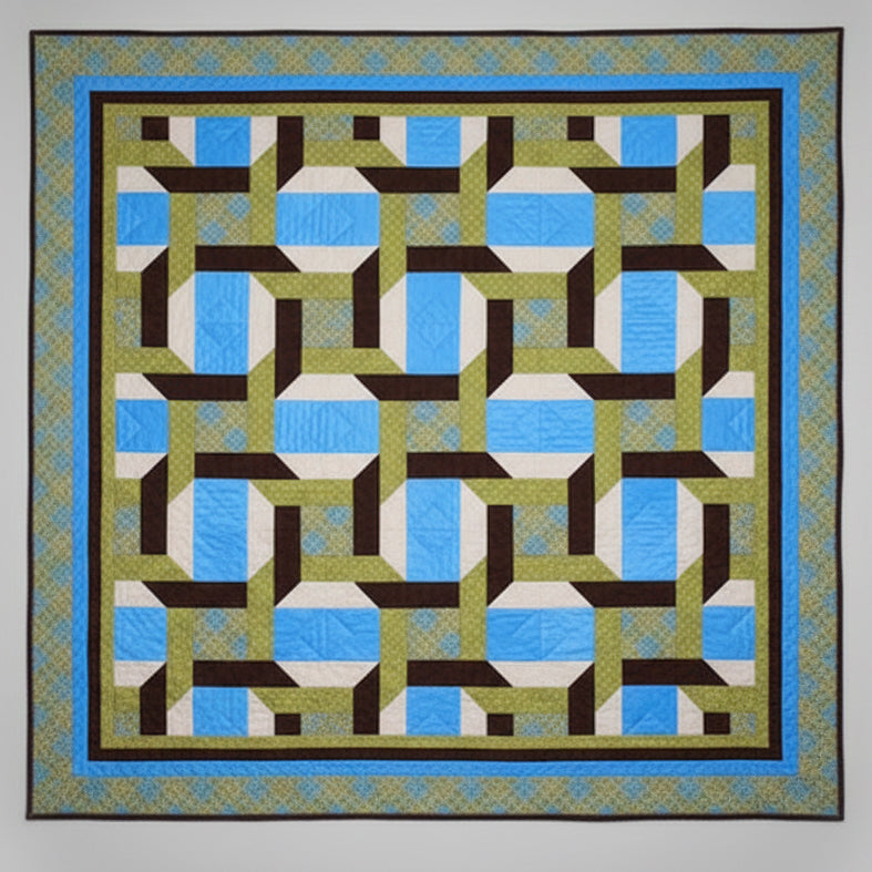 Quilt with geometric pattern featuring blue, brown, and green colors on a plain background
